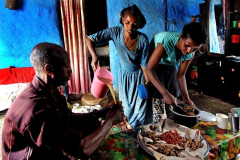 Family visit to Lalibela, two woman preparing meal on table, Lalibela, zero