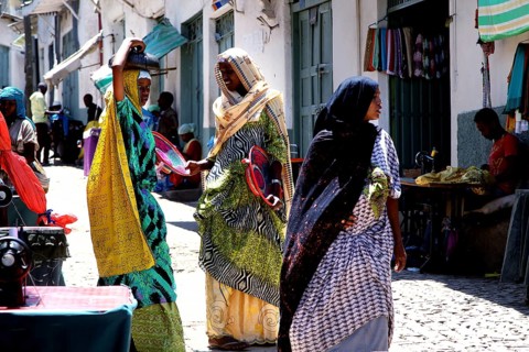 Women in Harar talking in a narrow alley, brightly dressed, Harar, Oromia, Ethiopia
