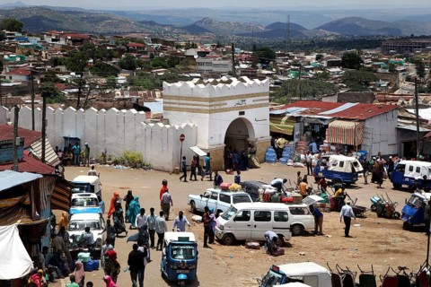 The Shoa Ber West Gate of Harar surrounded by busy markets and vehicles, Harar, Harari, Ethiopia
