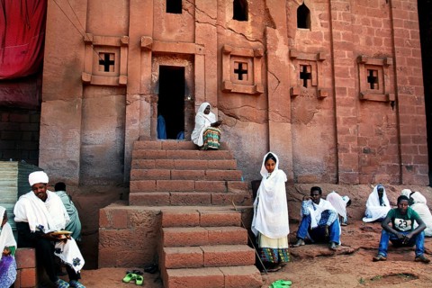 People wearing traditional dress in front of the rock church of Bete Abba Libanos in Lalibela,