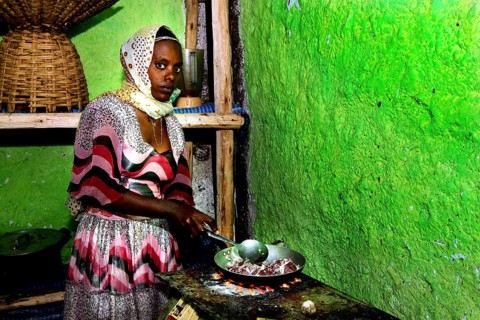 A woman prepares tibs in a traditional kitchen, Lalibela, Ethiopia