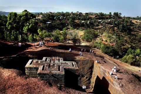 Aerial view of Bete Gyorgis surrounded by nature and pilgrims, Lalibela, Amhara, Ethiopia