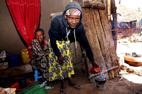 Two woman having a traditional coffee ceremony surrounded by warmth and warmth, Lalibela, Amhara,