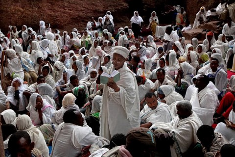 Believers in white robes gather for an Easter service in Bete Maryam, Lalibela, Ethiopia