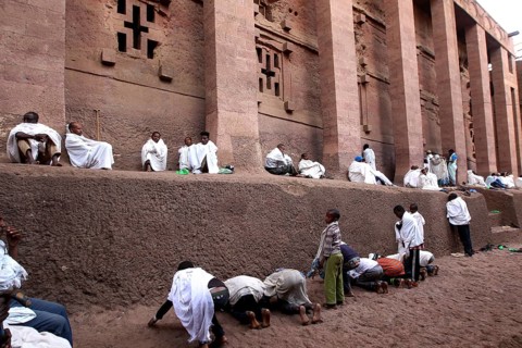 People wearing white robes pray at the Bete Medhane Alem Rock Church during Easter, Lalibela,