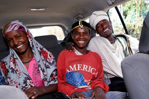 Three happy people in a Landcruiser in the Lasta Mountains. Modernity and tradition combined,