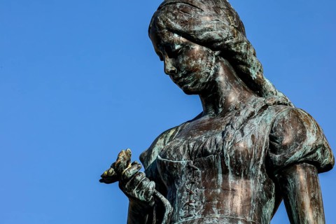 Detailed view of the Änchen von Tharau sculpture against a blue sky in Klaipeda, Klaipeda, Memel,
