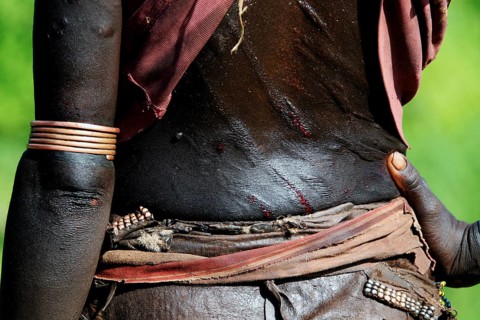 Close-up view of a Hamer initiation ritual with visible scars and traditional jewelry, Turmi,