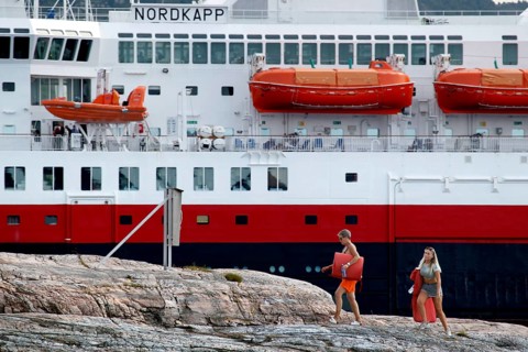 Hurtigruten ship in Kristiansund, dock with passengers and distinctive red lifeboats, Kristiansund,