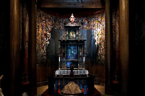 On display altar with ornate carvings in the stave church, Heddal, Norway
