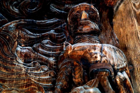 Wood-carved figure in the ornate door frame of the stave church in Heddal, Heddal, Norway