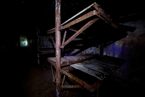 Dark abandoned bunker with rusty metal frames, Tahkuna, Hiiumaa, Estonia