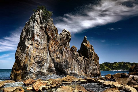 Weather-eroded rocks on the coast under a cloudy sky, Kushimoto, Wakayama, Japan