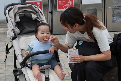 A mother feeds her child at a rest stop in Nagasaki, Nagasaki, Japan