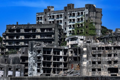 Impressive shot of Gunkanjima's crumbling urban structure seen from the sea, Nagasaki, Kyushu,