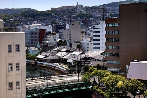 View of the Dutch trade base Dejima with modern buildings and surrounding landscape, Nagasaki,