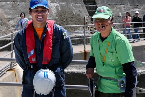 Two friendly guides during a shore trip on the deserted island of Gunkanjima, Nagasaki, Kyushu,