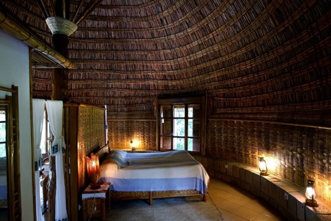 Cozy room at Aregash Lodge with thatched roof and wooden furniture, Yirga Alem, Ethiopia