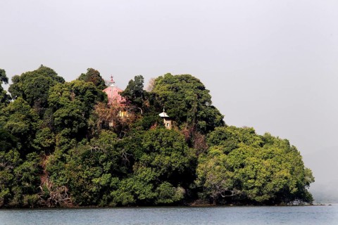 Wooded island in Lake Tana surrounded by calm water, zero