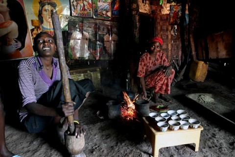 Women prepare traditional food at a fireplace in a hut, Yirga Alem, Ethiopia