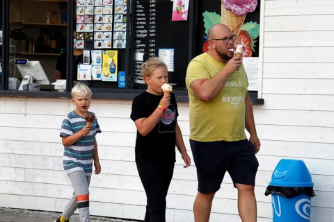 Family enjoying ice cream in front of an ice cream shop in Porvoo, Porvoo, Finland