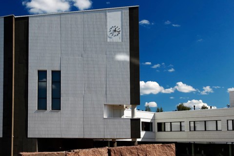Modern town hall building with typical Alvar Aalto architecture under blue sky, Rovaniemi, Finland