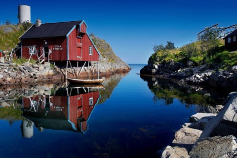 Red house reflected in calm water in Å, Moskenesøy, Å, Moskenesøy, Norway