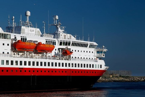 Hurtigruten ship on open sea against blue sky and calm water surface near Svolvær, Svolvær,