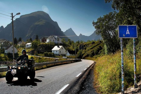 ATV on a road in Å, surrounded by the impressive mountain scenery of Lofoten, Å, Moskenesøy, Norway