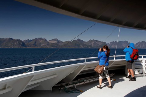 Passengers on a ferry look at the Lofoten Mountains, Lofoten, Norway