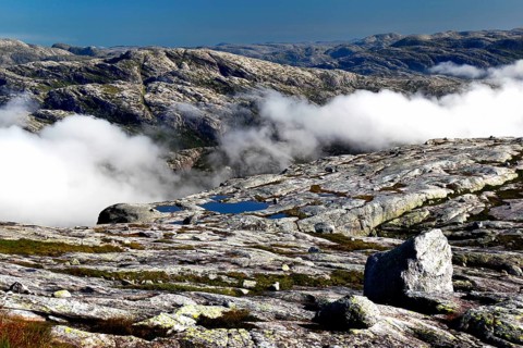 Wide plateau with clouds over a rocky landscape in Kjerag, Lysefjord, Rogaland, Norway
