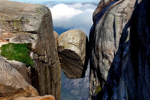 The Kjeragbolten is impressively enthroned between two majestic rock faces, Kjerag, Rogaland,