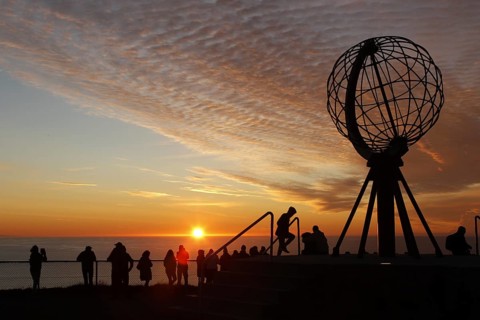 Crowd of people at the North Cape globe at a picturesque sunset, North Cape, Magerøya, Norway