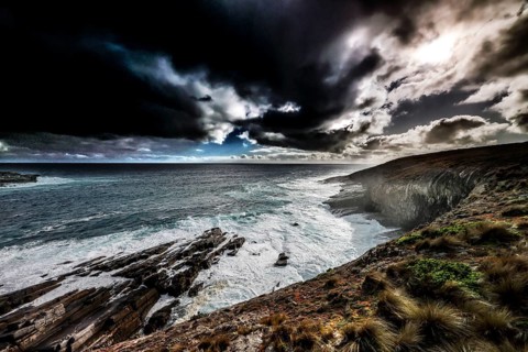Gloomy coastal atmosphere with strong waves and dark clouds near Cape du Couedic, Kangaroo Island,