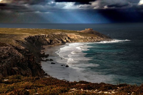 The dramatic coastline of Cape du Couedic with strong swell under dark skies, Kangaroo Island,