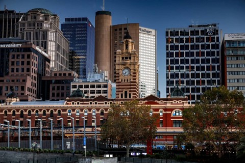 Flinders Street Station in Melbourne with surrounding modern buildings, Melbourne, Victoria,