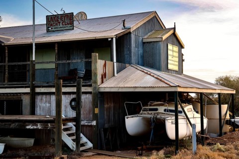 Rustic Lake Eyre Yacht Club building with moored boats in Marree, Marree, South Australia,