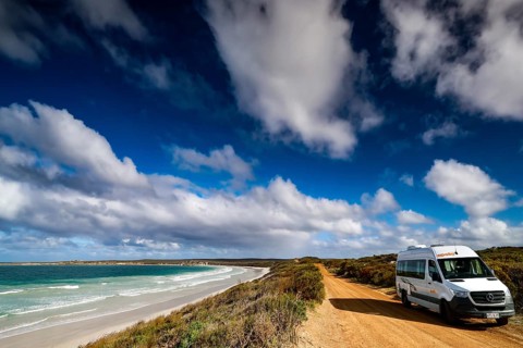 Campers on a sandy coastal road under a cloudy sky, Vivonne Bay, Kangaroo Island, Australia