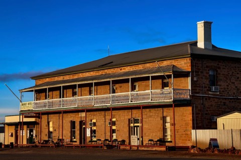 Historic Marree Hotel with impressive veranda and clear blue sky, Marree, South Australia,