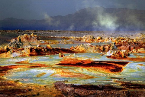 Dramatic geothermal scene in Dallol with smoke and mineral-rich rocks, Dallol, Afar region,