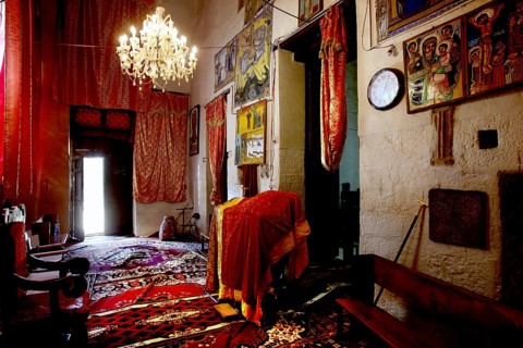 Rich interior of St. Mary's Cathedral in Axum with murals and chandeliers, Axum, Ethiopia