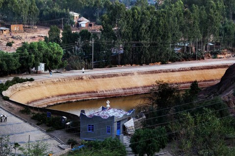 Historic view of Queen of Sheba's pond with lush green surroundings in Axum, Axum, Ethiopia