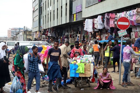 Diverse market life on the Mercato in Addis Ababa with colorful clothes and stalls, Addis Ababa,