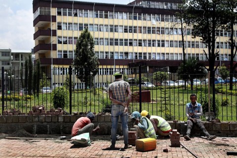 Workers maintaining sidewalks in front of a municipal building, Addis Ababa, Ethiopia