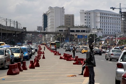 Dense traffic road with modern buildings in the background, Addis Ababa, Ethiopia