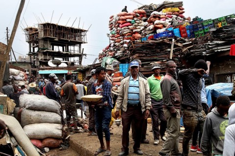 Merchants sell goods amid huge bales of fabric on the busy Mercato in Addis Ababa, Addis Ababa,