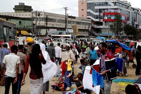 Bustling market area with lots of people and an urban backdrop, Addis Ababa, Mercato, Ethiopia