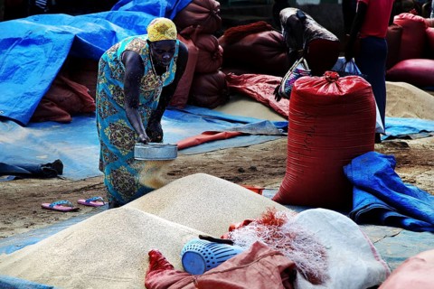 Market scene in Jinka with a woman selling Teff out of a sack