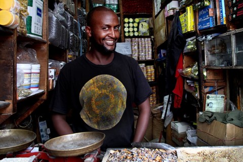 A friendly salesman stands in his shop full of spices in Mercato, Addis Ababa, Ethiopia