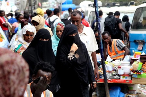 Veiled woman in a busy marketplace in Addis Ababa, Addis Ababa, Ethiopia